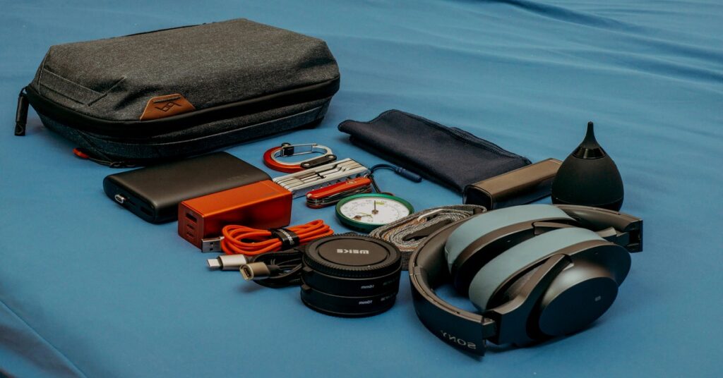 flatlay travel gear backpack packing cubes passport power bank
