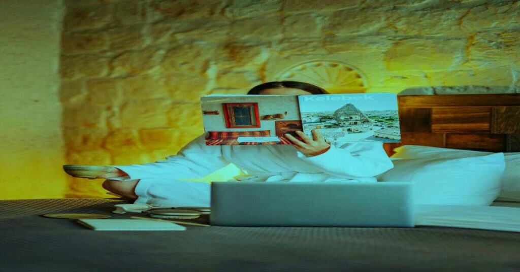 reading hotel reviews laptop travel planning