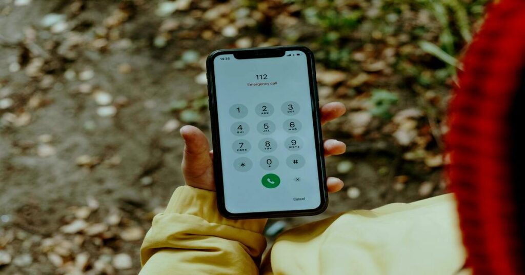 Close up woman hand activating emergency safety phone app on city street