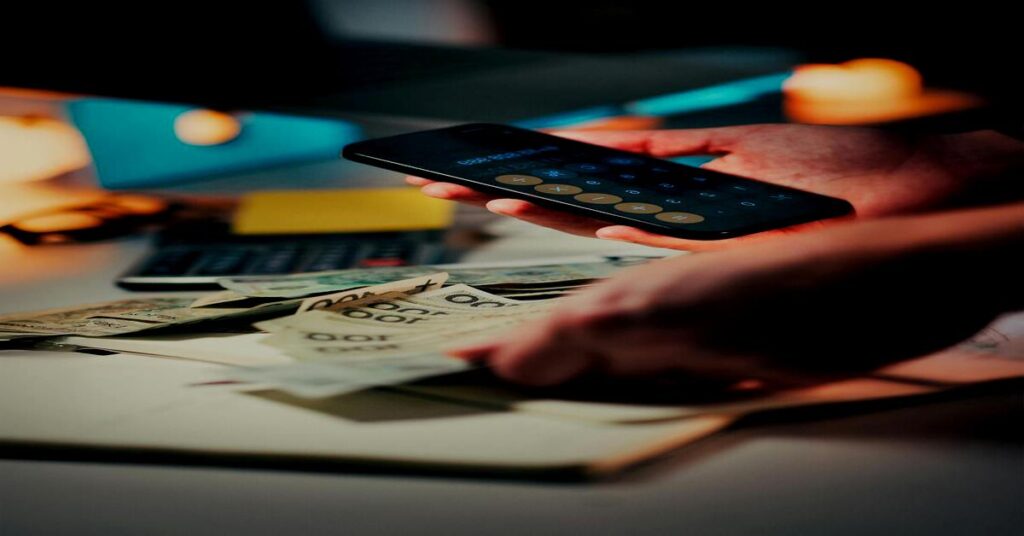 Independent tourist checking digital money tracker and converting foreign currency on smartphone