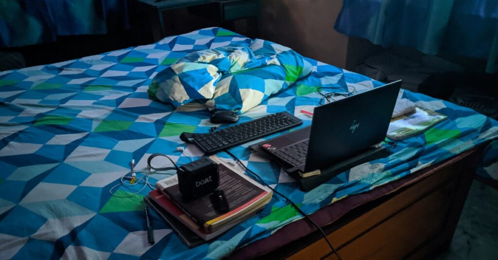 Solo Barter Travel: Swap Skills for Free US Adventures 7 Solo Barter Travel: Swap Skills for Free US Adventures, solo traveler using laptop in hostel