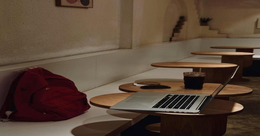 Slow vs Fast Travel: Which Saves You More Money? 3 anti theft travel backpack notebook cafe table