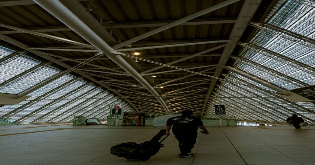 Slow vs Fast Travel: Which Saves You More Money? 5 lightweight carry on suitcase airport terminal floor