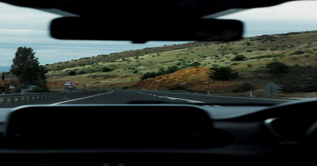 Solo road trip open highway mountain landscape car dashboard view