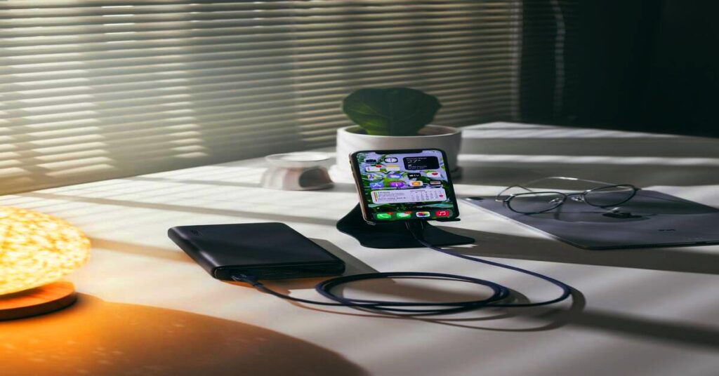 7 Best Power Bank Essentials for Travel for Flights and Road Trips 1 Power Bank Essentials for Travel charging phone on flight in airport lounge