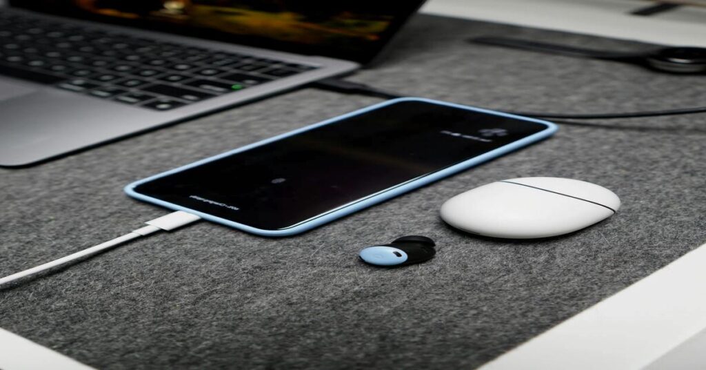 laptop smartphone charging on desk tech workspace