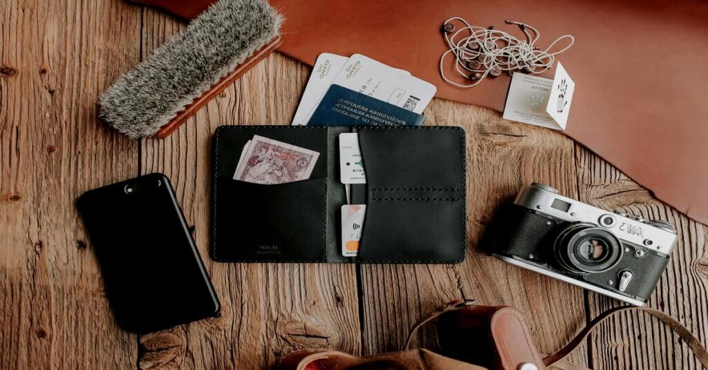 Minimal travel chargers laid out neatly flat next to a passport and minimalist carry-on packing essentials