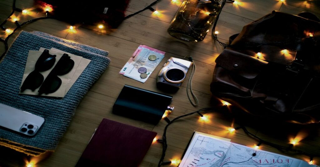 Universal travel adapters packed neatly inside an open suitcase flat-lay setup next to a passport and travel gear