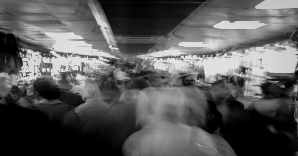 Busy outdoor street market crowd walking blurred
