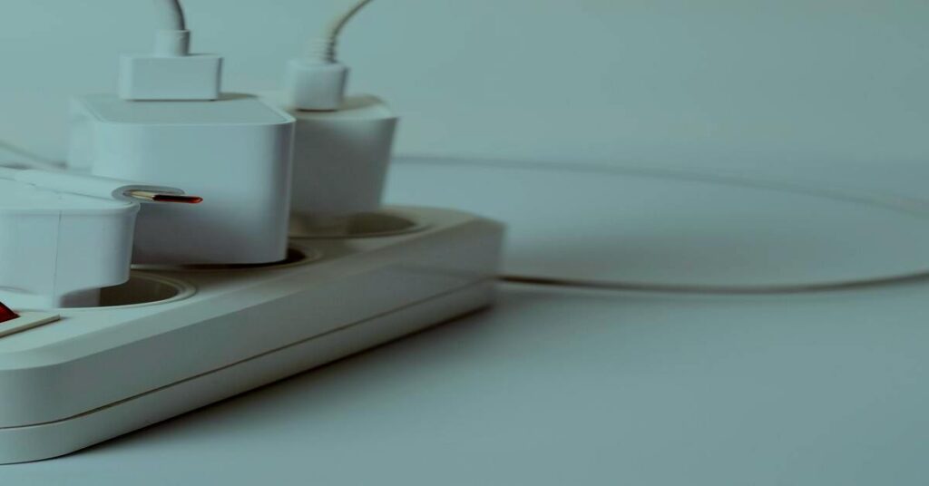 š International Travel Plug Adapter Guide: Safe Charging Tips for 2026 1 Charging multiple devices smartphones laptop desk hotel power