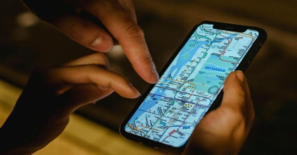 Close up smartphone hand mapping city navigation location street