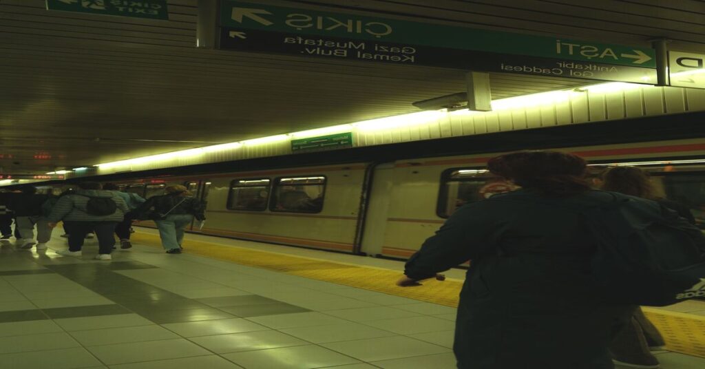 Crowded train station metro platform passengers blur