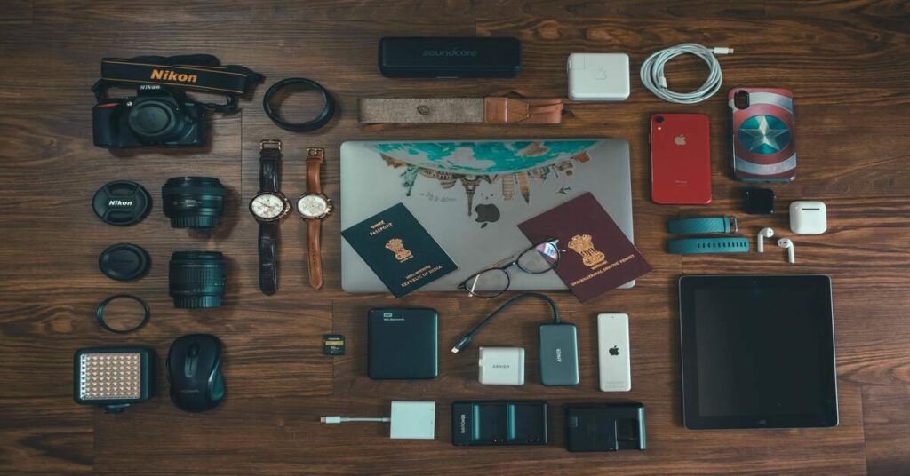 Flat lay travel gear lightweight passport wallet backpack charging adapter