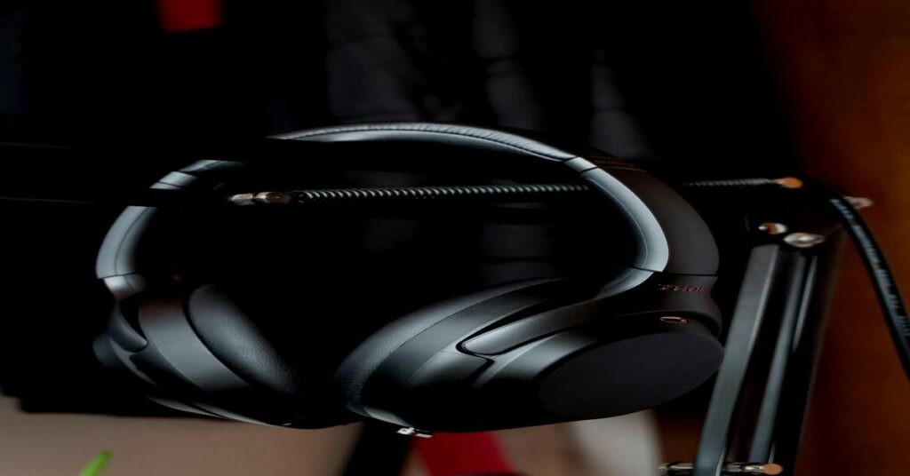 Noise-canceling headphones for travel resting on an airplane seat