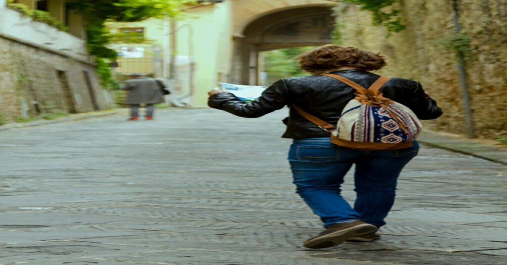 Solo Travel Safety Tips Checklist applied by a single traveler mapping out her route on a city street