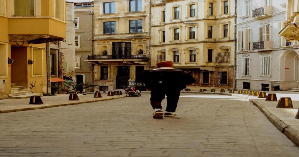 Solo travel safety tips for first-time backpackers walking safely down an urban European street view from behind