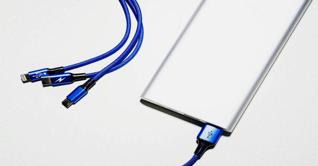 Tech gadgets backpack charging multiple devices cables flatlay hands free