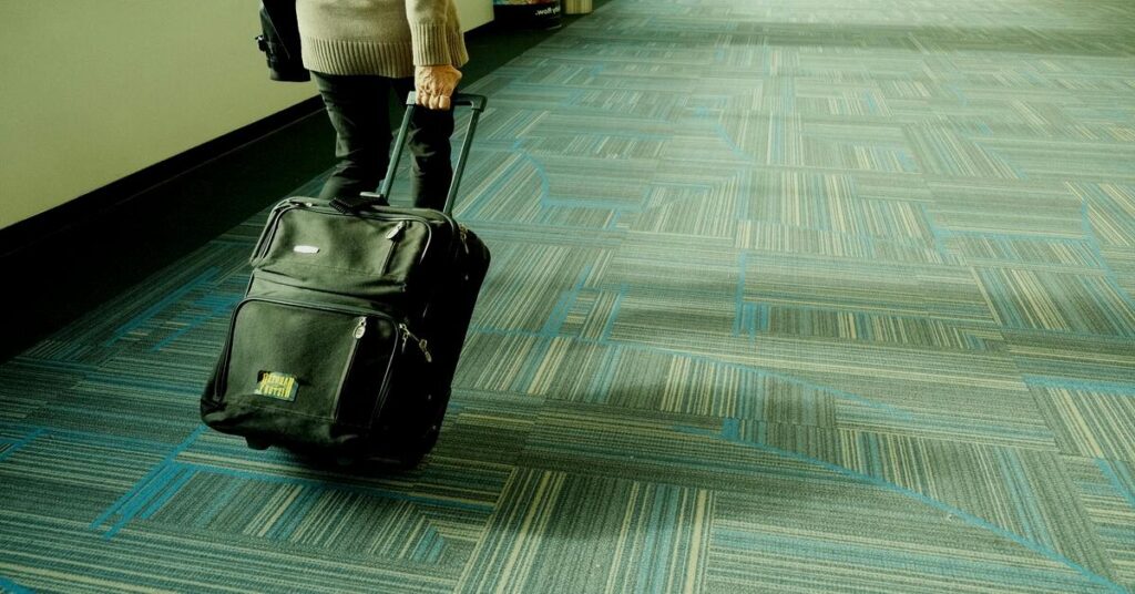 Traveler luggage suitcase backpack airport terminal terminal walkway