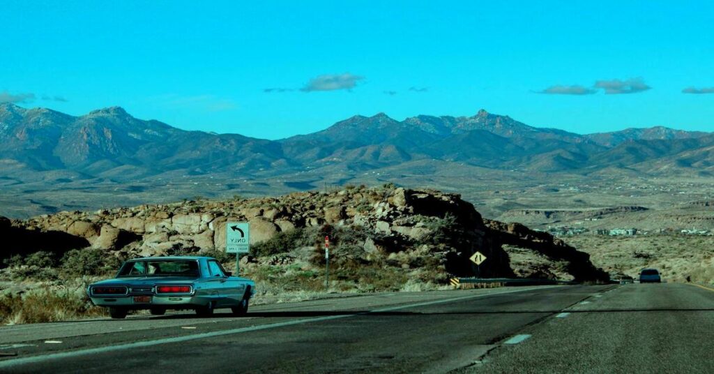 Best Solo Road Trips in the USA scenic highway view with solo traveler car