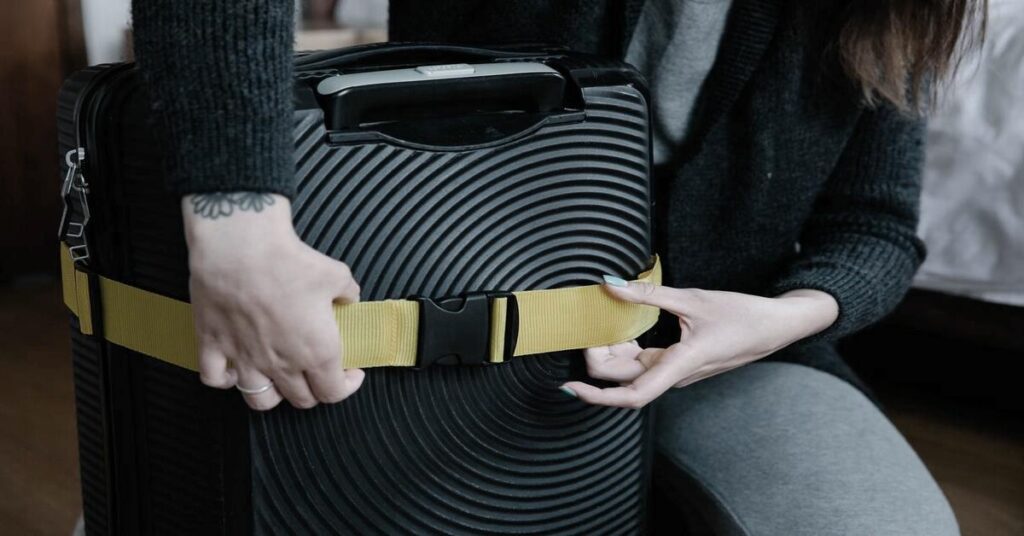 digital luggage scale hand holding suitcase weighing travel tool