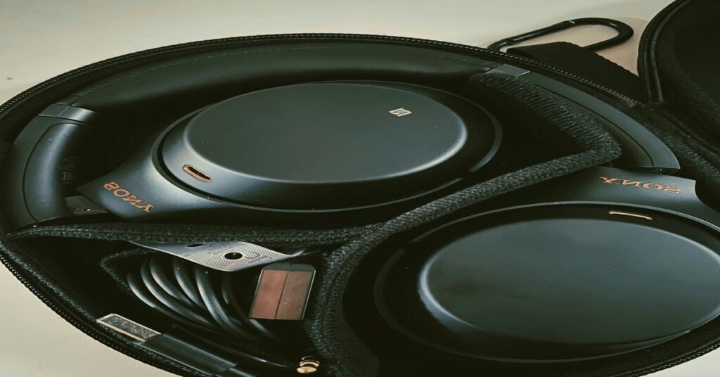 Best Noise-Canceling Headphones for Travel (2026 Flight Guide) 5 headphones for travel inside protective hard storage case