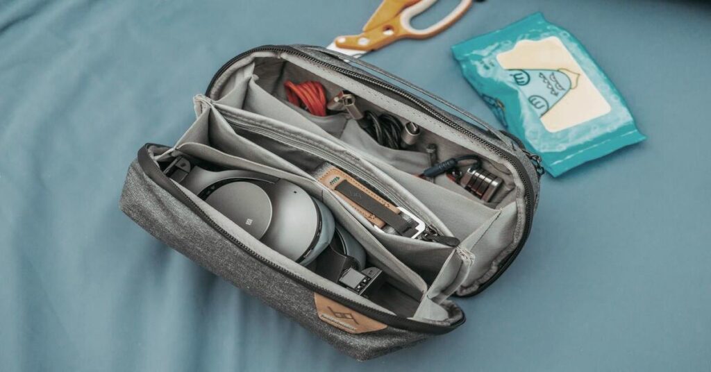 shows messy tangled cables inside travel bag before organization