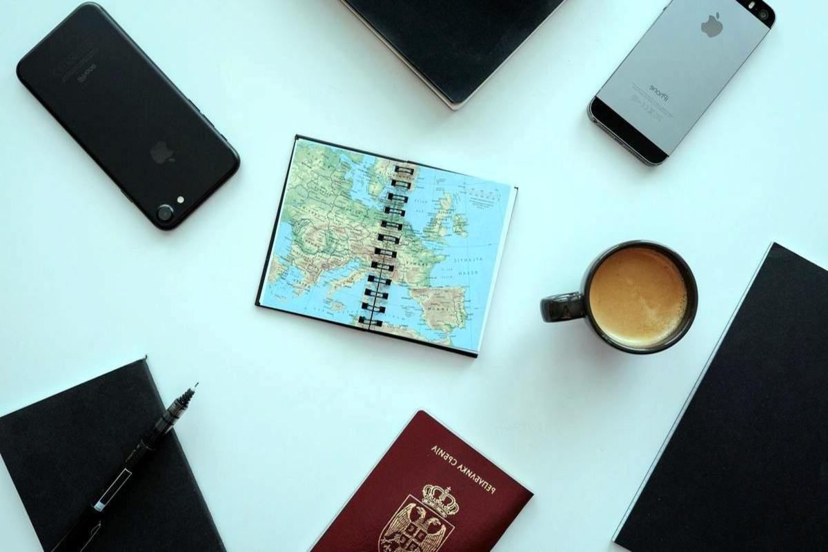 About Us solo travel guide traveler planning international trip on laptop with notes and map