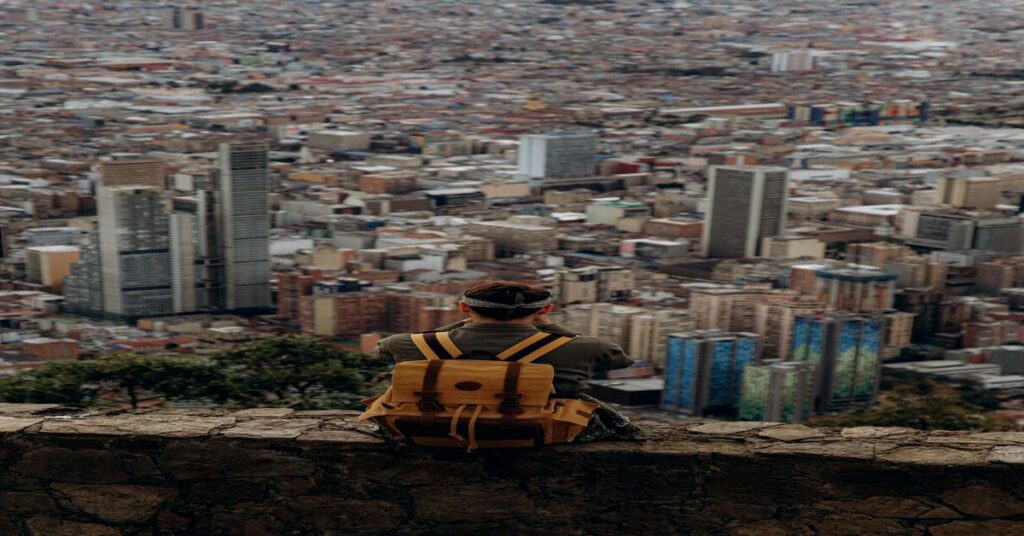 11 Best US Solo Travel Destinations featured image of a solo traveler exploring an American city skyline street