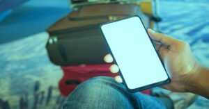 🌍 SOLO TRAVEL GUIDE 11 Best Power Bank for Travel showing suitcase airport setup with phone charging on power bank