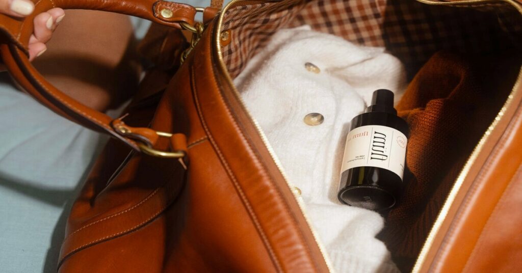 Best Wrinkle Release Spray for Travel featured image of suitcase layout