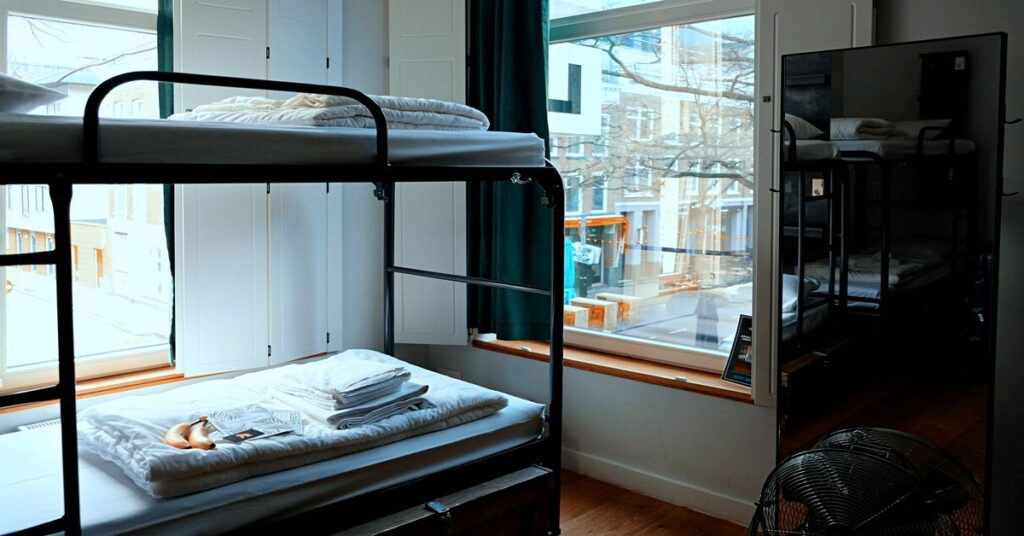 backpacker hostel bunk bed laundry drying setup no faces