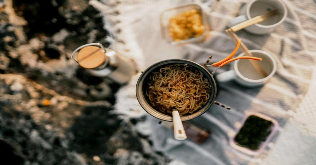 hostel kitchen travel cooking instant noodles coffee layover traveler