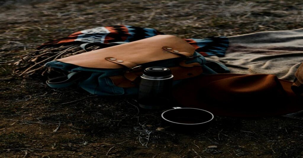 packed backpack with compact travel kettle and essential travel gear