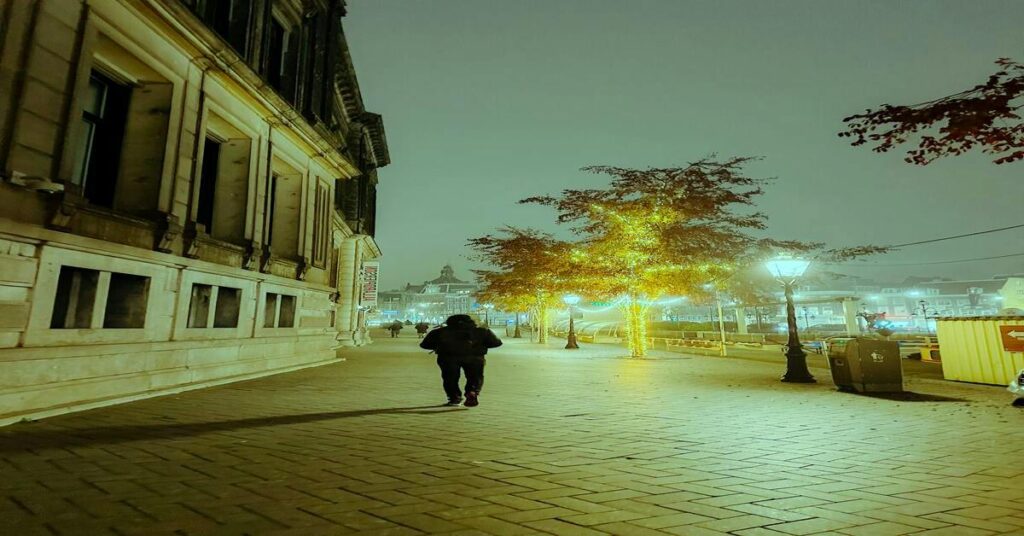 solo traveler walking alone city evening street light travel anxiety