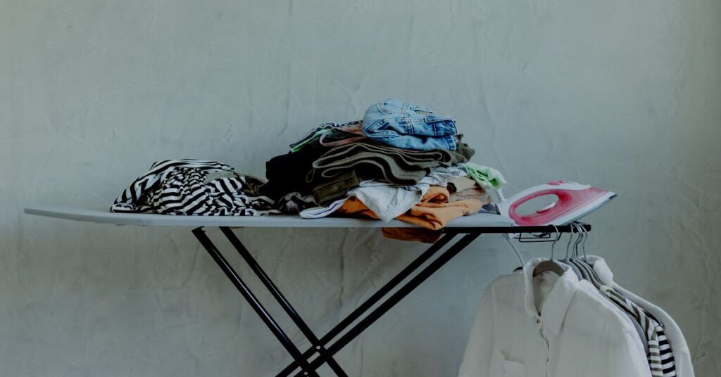 Best travel mini iron for hostel packing layouts neatly placed next to a backpack and clean clothes