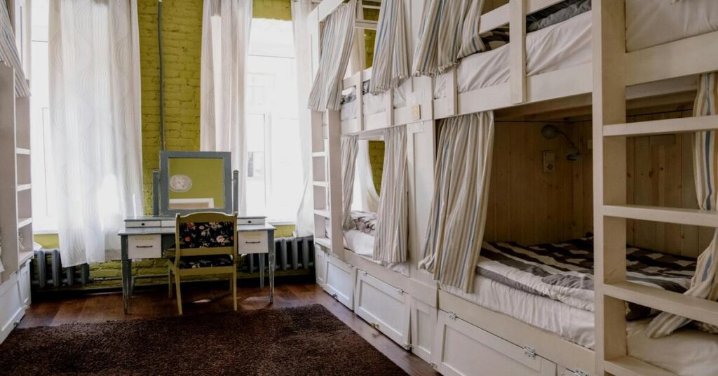 Cozy hostel dorm room interior with wooden bunks