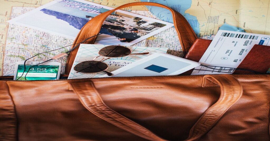 Hand luggage passport boarding pass on table