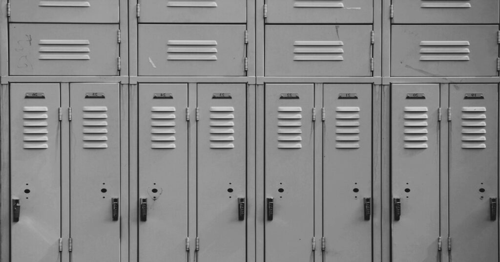 Best Portable Biometric Travel Safe for Hostel Rooms (2026) 3 hostel lockers anchored using a heavy duty steel cable system to stop theft