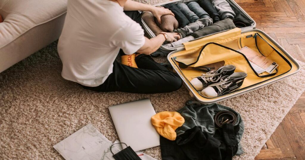 packed suitcase with clothes and shoes for travel