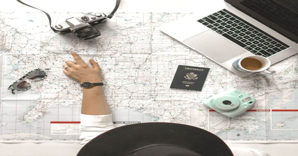 Best Portable Biometric Travel Safe for Hostel Rooms (2026) 5 person hands pointing travel map passport coffee laptop