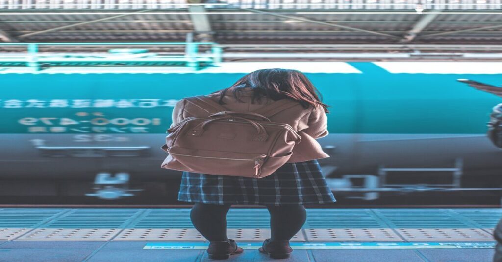 subway train station night platform luggage hands free